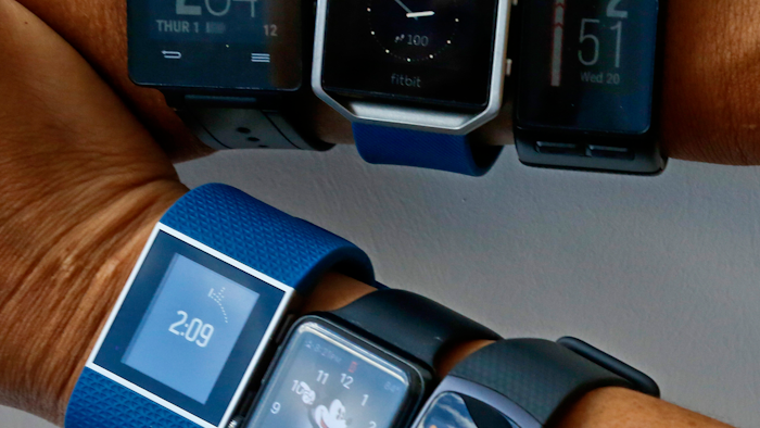 In this July 20, 2016 file photo, six fitness tracking devices measuring step counts and other fitness features are worn in New York.