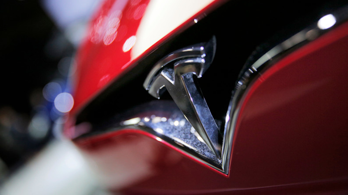 This Friday, Sept. 30, 2016, file photo shows the logo of the Tesla Model S on display at the Paris Auto Show in Paris.