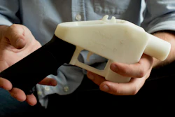 In this May 10, 2013, file photo, Cody Wilson holds what he calls a Liberator pistol that was completely made on a 3-D-printer at his home in Austin, Texas.
