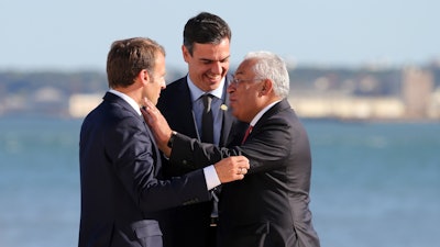 French President Emmanuel Macron, Spanish Prime Minister Pedro Sanchez, Portuguese Prime Minister Antonio Costa, from left to right, share a laugh after a group picture during the Summit for Energy Interconnections at the European Maritime Safety Agency headquarters in Lisbon.