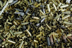 Empty bullet casings sit in a container at the National Armory gun store and gun range in Pompano Beach, Fla.