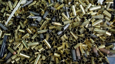 Empty bullet casings sit in a container at the National Armory gun store and gun range in Pompano Beach, Fla.