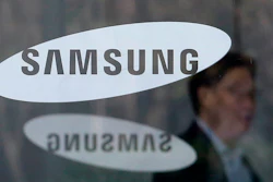 In this April 6, 2018, file photo, an employee walks past logos of the Samsung Electronics Co. at its office in Seoul, South Korea.