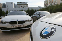 BMW cars are parked for an emergency safety check at the playground of an elementary school near a BMW service center in Seoul, South Korea, Tuesday, Aug. 14, 2018.