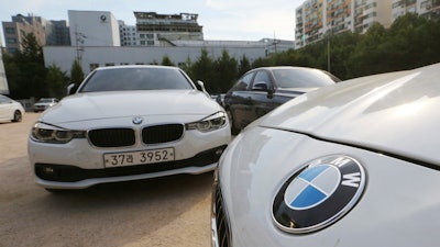BMW cars are parked for an emergency safety check at the playground of an elementary school near a BMW service center in Seoul, South Korea, Tuesday, Aug. 14, 2018.