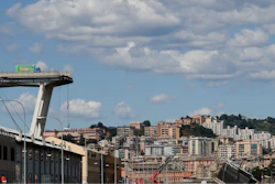 A truck perches on the edge of the Morandi highway bridge that collapsed in Genoa, northern Italy, Wednesday, Aug. 15, 2018.