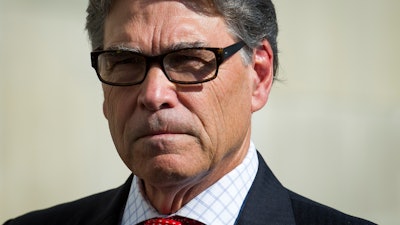 In this July 26, 2018 file photo, Secretary of Energy Rick Perry speaks with reporters at Dominion Energy's Cove Point LNG liquefaction Project facility in Lusby, Md.