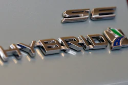 This Feb. 14, 2013, file photo shows a hybrid logo on the back of a Ford Fusion hybrid automobile at the 2013 Pittsburgh Auto Show in Pittsburgh.