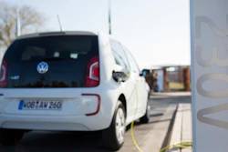 In this March 8, 2014 photo a Volkswagen e-up electric car is recharged on a recharging station in front of a building of the Volkswagen AG in Wolfsburg, Germany.