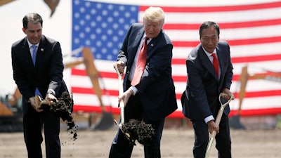 In this June 28, 2018, file photo, President Donald Trump, center, along with Wisconsin Gov. Scott Walker, left, and Foxconn Chairman Terry Gou participate in a groundbreaking event for the new Foxconn facility in Mt. Pleasant, Wis.