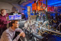 Sandia National Laboratories researchers Michael Chandross, left, and Nic Argibay show a computer simulation used to predict the unprecedented wear resistance of their platinum-gold alloy, and an environmental tribometer used to demonstrate it.