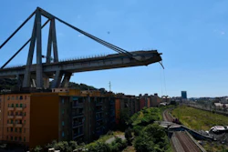 A view of the evacuated houses built under the remains part of the collapsed Morandi highway bridge, in Genoa, northern Italy, Wednesday, Aug. 15, 2018.