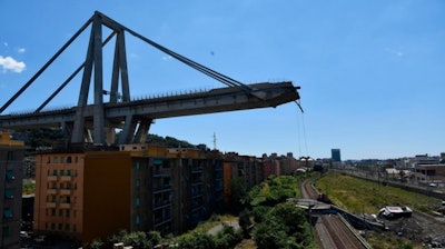 A view of the evacuated houses built under the remains part of the collapsed Morandi highway bridge, in Genoa, northern Italy, Wednesday, Aug. 15, 2018.