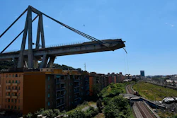 A view of the evacuated houses built under the remains part of the collapsed Morandi highway bridge, in Genoa, northern Italy, Wednesday, Aug. 15, 2018.