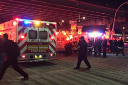 First responders carry a person to an ambulance after a helicopter crashed into the East River along New York on Sunday, March 11, 2018.
