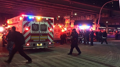 First responders carry a person to an ambulance after a helicopter crashed into the East River along New York on Sunday, March 11, 2018.