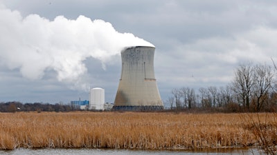 In this Tuesday, April 4, 2017, file photo, plumes of steam drift from the cooling tower of FirstEnergy Corp.'s Davis-Besse Nuclear Power Station in Oak Harbor, Ohio.