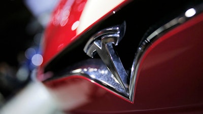 This Sept. 30, 2016, file photo shows the logo of the Tesla Model S on display at the Paris Auto Show in Paris.