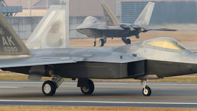 U.S. Air Force F-22 Raptors taxi on the runway upon landing at a South Korean air base in Gwangju, South Korea, Monday, Dec. 4, 2017.
