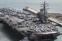 In this Oct. 21, 2017 photo, the aircraft carrier USS Ronald Reagan (CVN 76) is escorted into Busan port, South Korea, after completing a joint drill with the South Korean military.