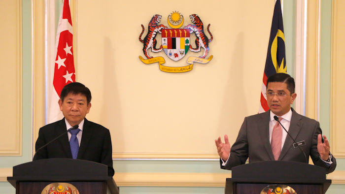 Malaysia's Minister of Economic Affair Mohamed Azmin Ali, right, and Minister for Infrastructure and Minister for Transport of Singapore Khaw Boon Wan, left, speak during a press conference at Prime Minister Office in Putrajaya, Malaysia, Wednesday, Sept. 5, 2018.