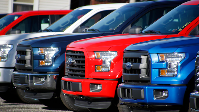 In this Nov. 19, 2015, file photo a row of 2015 Ford F-150 pickup trucks are parked on the sales lot at Butler County Ford in Butler, Pa.