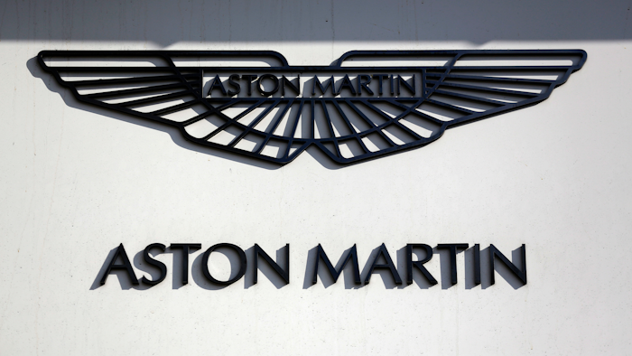 In this file photo dated Wednesday, Feb. 24, 2016, an Aston Martin sign is seen outside a dealership on Park Lane in London.