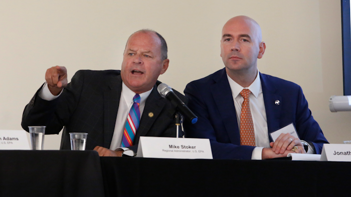 Mike Stoker regional administrator of the US EPA directs speakers as Jonathan Morrison of NHTSA looks on during the first of three public hearings on the Trump administration's proposal to roll back car-mileage standards in a region with some of the nation's worst air pollution Monday, Sept. 24, 2018 in Fresno, Calif.