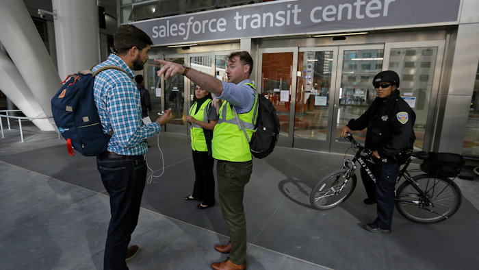 Mike Eshleman, with AC Transit, directs people away from the Salesforce Transit Center following its closure, Tuesday, Sept. 25, 2018, in San Francisco.