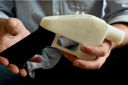 In this May 10, 2013, file photo, Cody Wilson holds what he calls a Liberator pistol that was completely made on a 3-D-printer at his home in Austin, Texas.