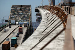 In this July 2, 2018, photo, traffic moves on the old Gerald Desmond Bridge next to its replacement bridge under construction in Long Beach, Calif.