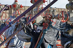 In this March 25, 2014 file photo, a worker adjusts pipes during a hydraulic fracturing operation at a well pad near Mead, Colorado.