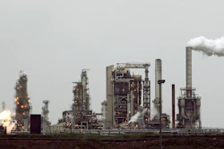 This April 2, 2010 file photo shows a Tesoro Corp. refinery, including a gas flare flame that is part of normal plant operations, in Anacortes, Wash.