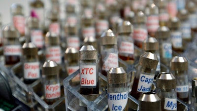 This Dec. 4, 2013 file photo shows vials of flavored liquid at a store selling electronic cigarettes and related items in Los Angeles.