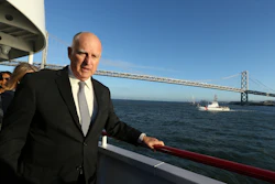 California Gov. Jerry Brown walks to the bow of the high-tech battery-operated San Francisco Bay sightseeing boat, Enhydra, for a cruise of San Francisco Bay, where he signed 16 new laws aimed at easing global warming.