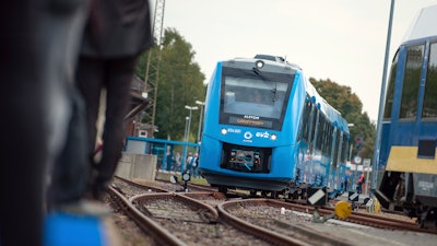 In this Sept. 16, 2018 photo a fuel cell train which is powered by hydrogen arrives in Bremervoerde, northern Germany. It is one of two trains that will go into regular service in 2019.