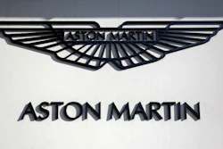 In this file photo dated Wednesday, Feb. 24, 2016, an Aston Martin sign is seen outside a dealership on Park Lane in London.