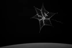 In this September 2018 image made from video provided by the University of Surrey, a net is launched from the International Space Station to catch a test object.