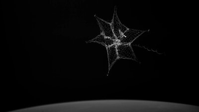 In this September 2018 image made from video provided by the University of Surrey, a net is launched from the International Space Station to catch a test object.