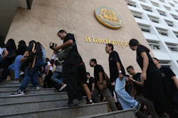 Plaintiffs of Ford cars with bad transmissions walk to inside civil court before a verdict in a class-action lawsuit in Bangkok, Thailand, Friday, Sept. 21, 2018.