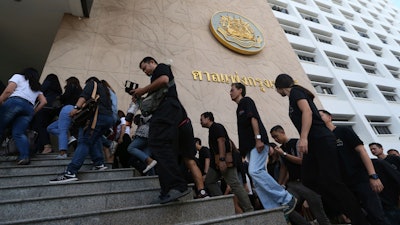 Plaintiffs of Ford cars with bad transmissions walk to inside civil court before a verdict in a class-action lawsuit in Bangkok, Thailand, Friday, Sept. 21, 2018.