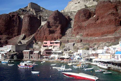 In this Sept. 21, 2009 file photo, boats are seen on Ammoudi Bay near seaside tavernas on the island of Santorini, Greece.