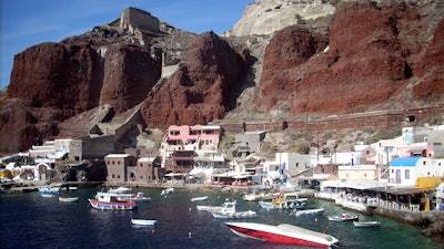 In this Sept. 21, 2009 file photo, boats are seen on Ammoudi Bay near seaside tavernas on the island of Santorini, Greece.