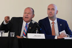 Mike Stoker regional administrator of the US EPA directs speakers as Jonathan Morrison of NHTSA looks on during the first of three public hearings on the Trump administration's proposal to roll back car-mileage standards in a region with some of the nation's worst air pollution Monday, Sept. 24, 2018 in Fresno, Calif.
