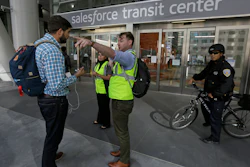 Mike Eshleman, with AC Transit, directs people away from the Salesforce Transit Center following its closure, Tuesday, Sept. 25, 2018, in San Francisco.