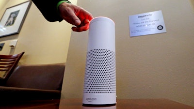 In this May 17, 2017, file photo, an Amazon Alexa device is switched on for a demonstration of its use in a ballpark suite before a Seattle Mariners baseball game in Seattle.