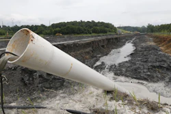 In this Friday June 26, 2015 file photo, a drain pipe sticks out of a coal ash retention pond at the Dominion Power’s Possum Point Power Station in Dumfries, Va.