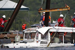 The duck boat that sank in Table Rock Lake in Branson, Mo., is raised Monday, July 23, 2018.