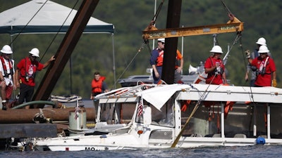 The duck boat that sank in Table Rock Lake in Branson, Mo., is raised Monday, July 23, 2018.