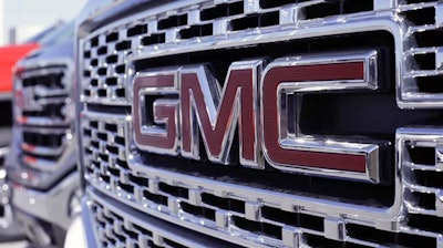 In this April 25, 2017, photo, a GMC truck sits in a General Motors dealer's lot in Nashville, Tenn.